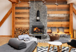 A cozy cabin interior with a burning fireplace