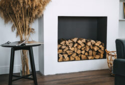 Firewood for a fireplace on a shelf in the living room interior.